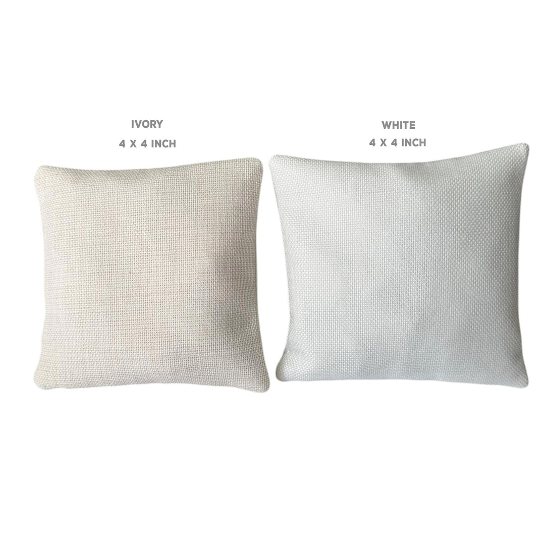 two square pillows, one white and one ivory, with the text "IVERY" and "WHITE" above them, indicating the color of the pillows.