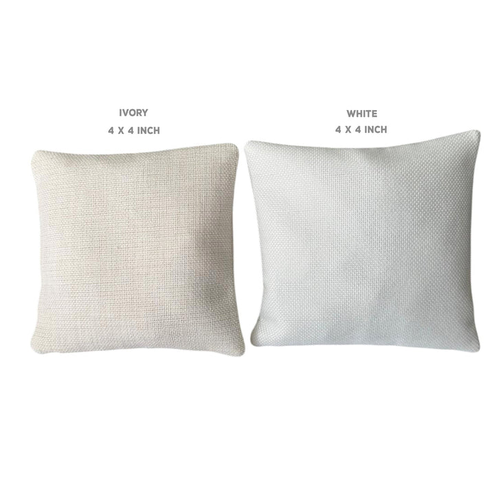 two square pillows, one white and one ivory, with the text "IVERY" and "WHITE" above them, indicating the color of the pillows.