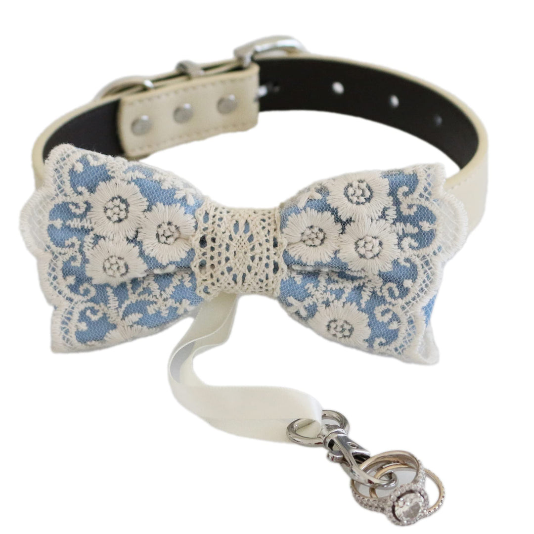 Blue floral lace ring bearer dog bow tie attached to an ivory vegan leather collar with wedding ring holder ribbon
