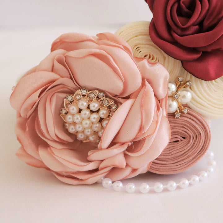 Blush pink and burgundy floral ring bearer dog collar with pearl embellishments, ivory vegan leather collar, and elegant flower arrangement