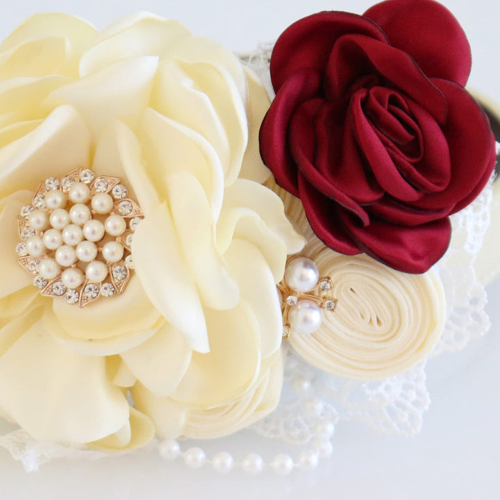 Close-up of ivory flower dog collar with burgundy satin rose, pearl accents, lace details, and handmade floral arrangement.