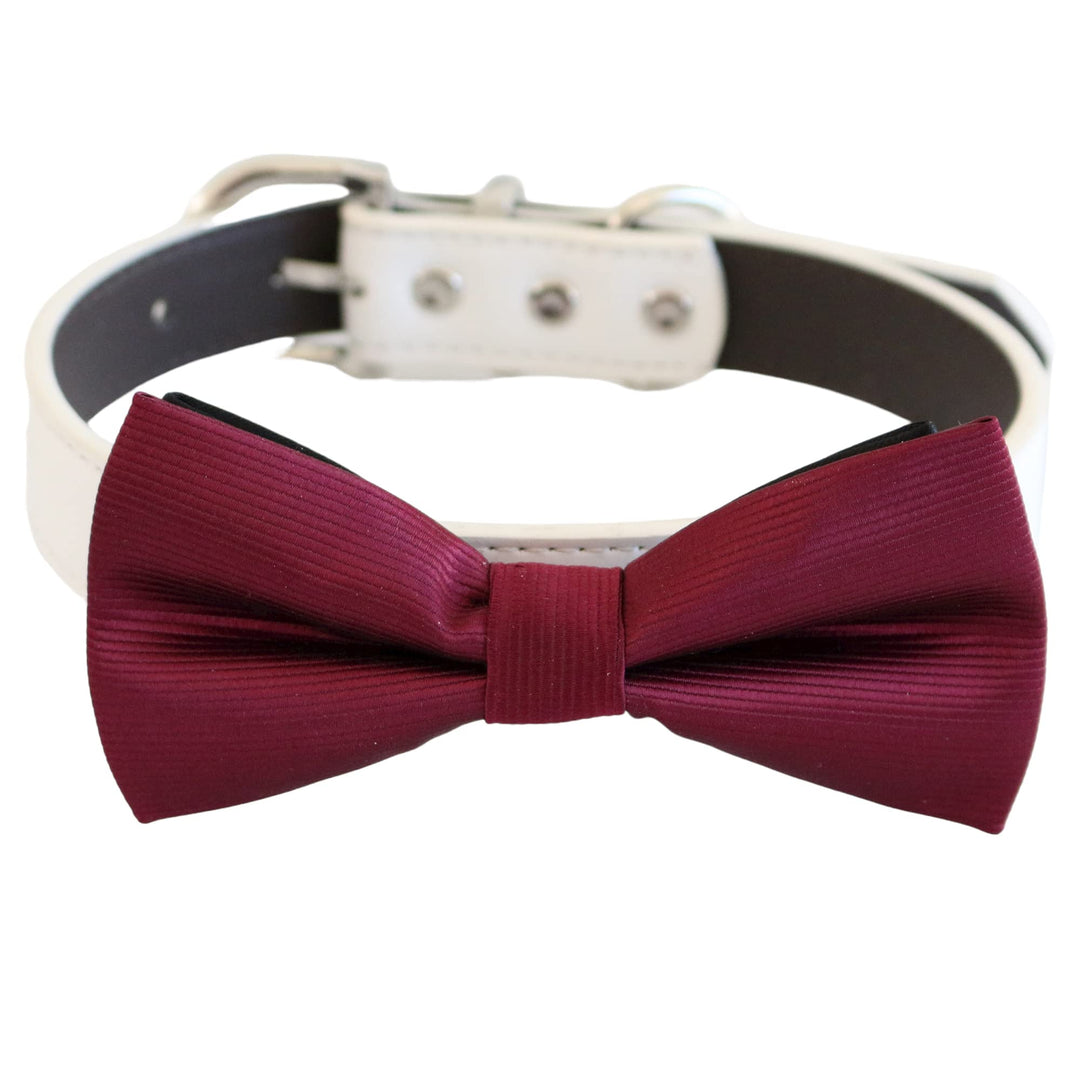 Burgundy ribbed dog bow tie attached to a white vegan leather collar with silver hardware and adjustable fit
