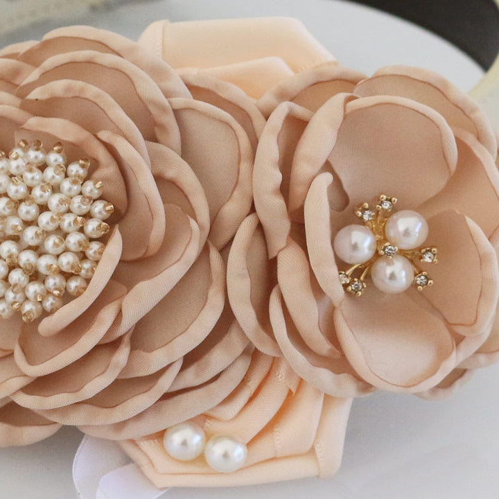 Champagne floral ring bearer dog collar with pearl flower centers, layered fabric flowers, and decorative wedding ring charm