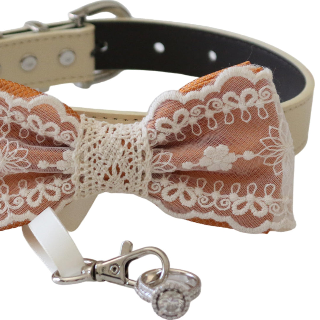 Copper lace ring bearer dog bow tie close-up featuring embroidered floral lace pattern, decorative center wrap, and attached wedding ring holder ribbon