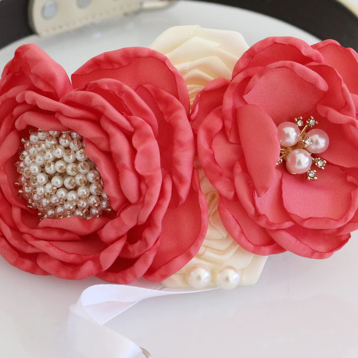 Close-up of coral and ivory ring bearer dog collar with handmade floral arrangement, pearl flower centers, and wedding ring holder ribbon.