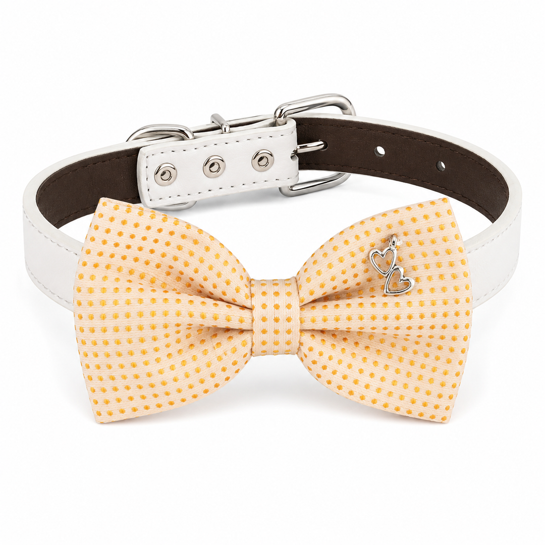 Cream dog bow tie collar with gold mini dot pattern, silver double heart charm, white vegan leather collar, and silver-tone hardware
