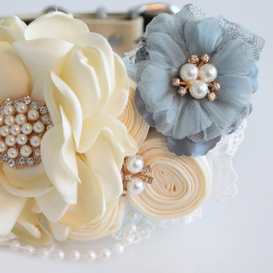 Close-up of ivory floral dog collar with dusty blue flower, pearl accents, lace details, and handmade floral arrangement.