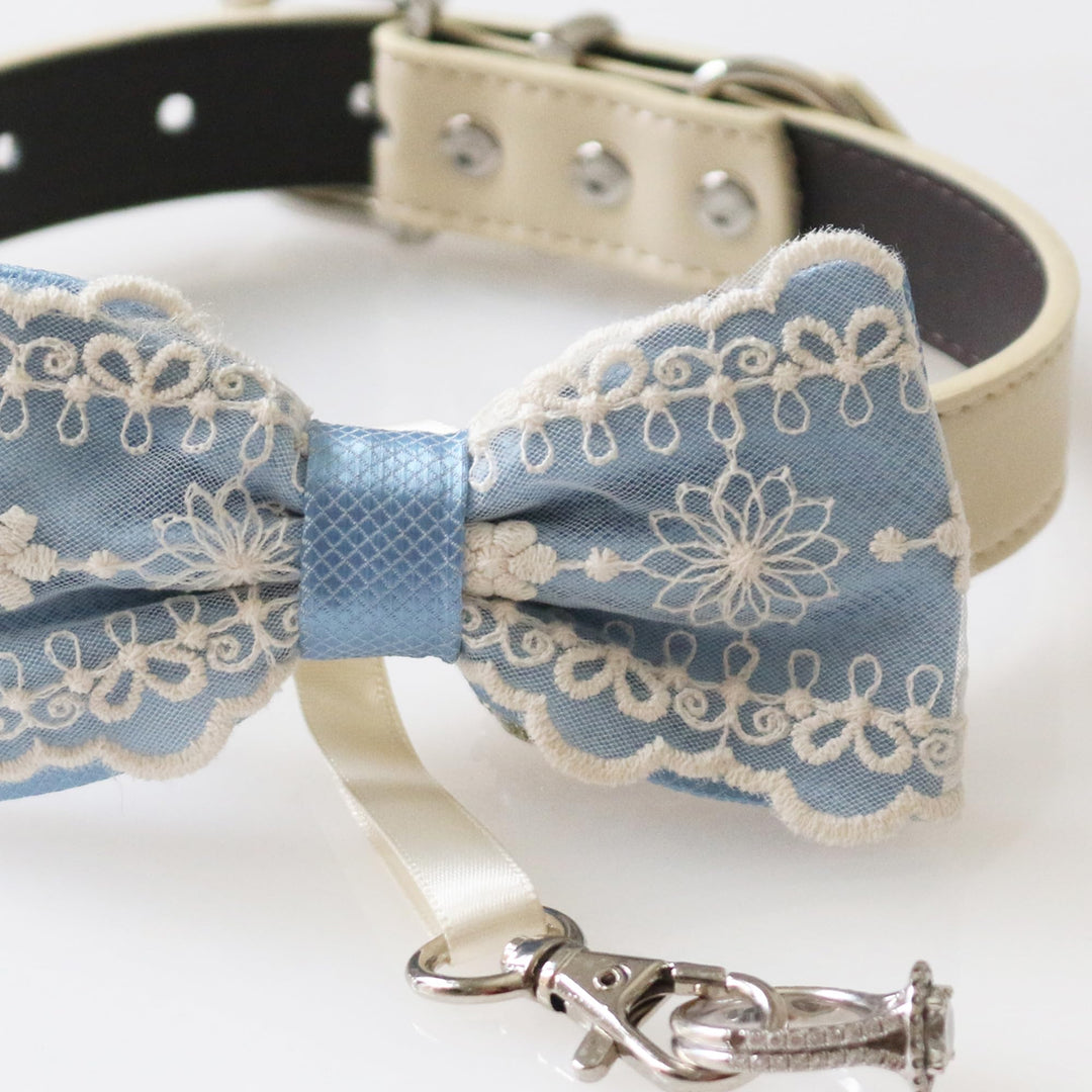 Dusty blue lace ring bearer dog bow tie collar with embroidered floral lace overlay, blue satin center accent, adjustable vegan leather collar, and attached wedding ring holder ribbon