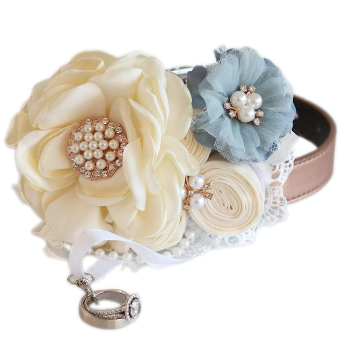 Handmade floral dog wedding collar featuring ivory flowers, dusty blue accent flower, pearl embellishments, and ring bearer ribbon attachment.