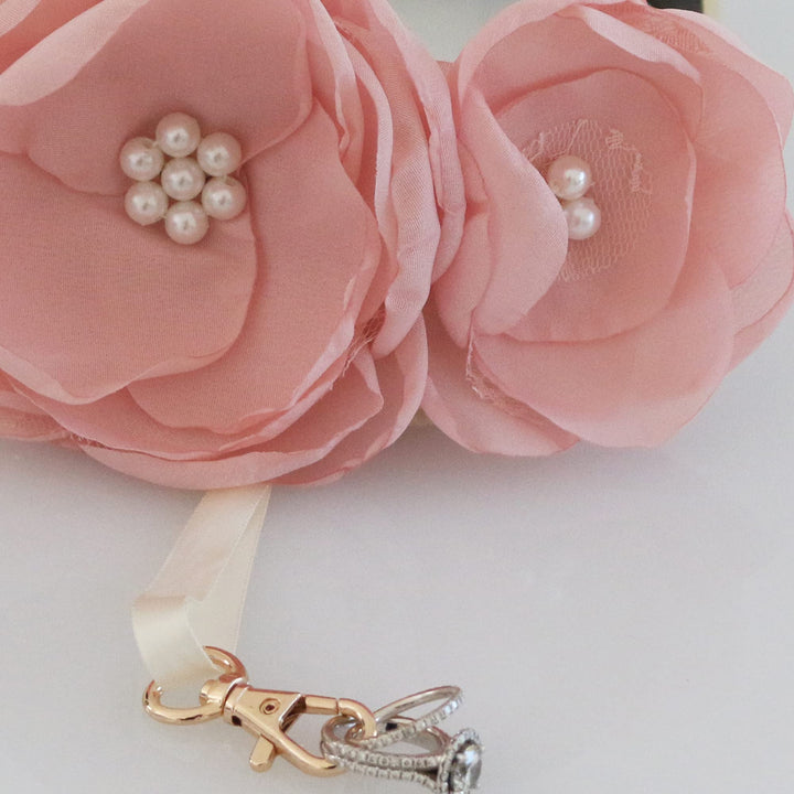 Close-up of dusty pink floral ring bearer dog collar with pearl flower centers and detachable ring holder ribbon