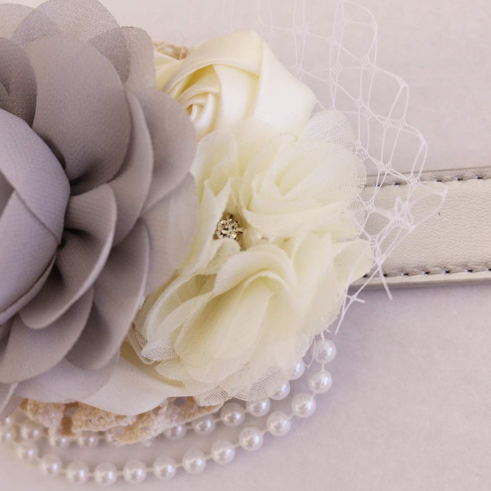 Close-up of gray chiffon flower dog collar with ivory rose accents, pearl strand detail, and crystal centerpiece.