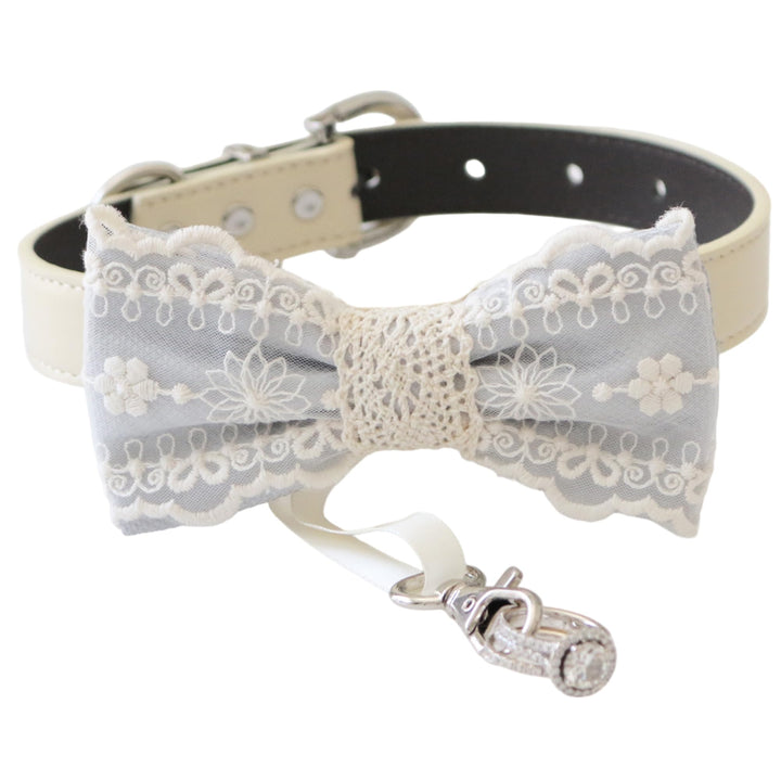Gray lace ring bearer dog bow tie collar with embroidered lace design, attached wedding ring holder ribbon, decorative ring charm, and adjustable vegan leather collar for weddings and special occasions