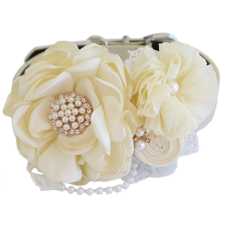 Ivory bridal dog collar with pearl centerpiece, chiffon flower accent, lace details, and elegant floral arrangement.