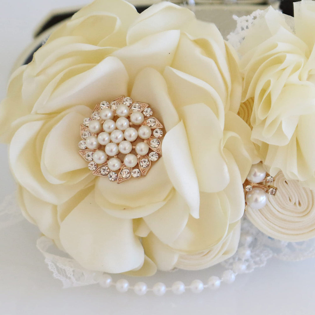 Detailed view of ivory wedding dog collar with layered fabric flower, pearl accents, and handcrafted rosette flowers.