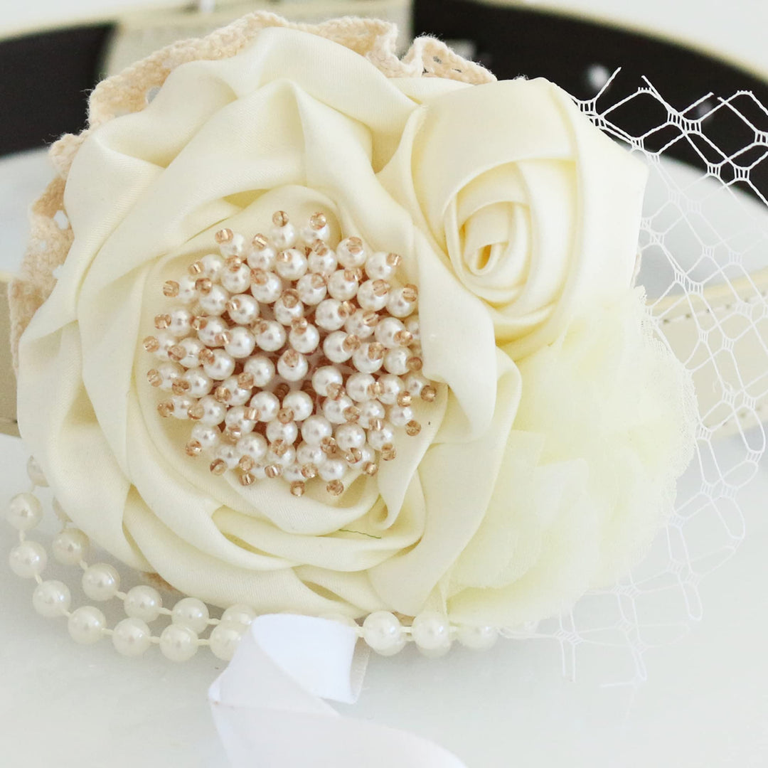 Ivory floral ring bearer dog collar with pearl centerpiece, lace detail, pearl trim, and decorative charm.