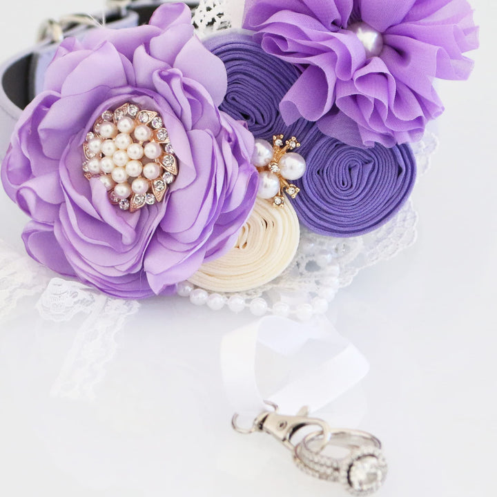 Close-up of lilac floral ring bearer dog collar with pearl centerpiece, ribbon roses, lace trim, and ring holder ribbon.