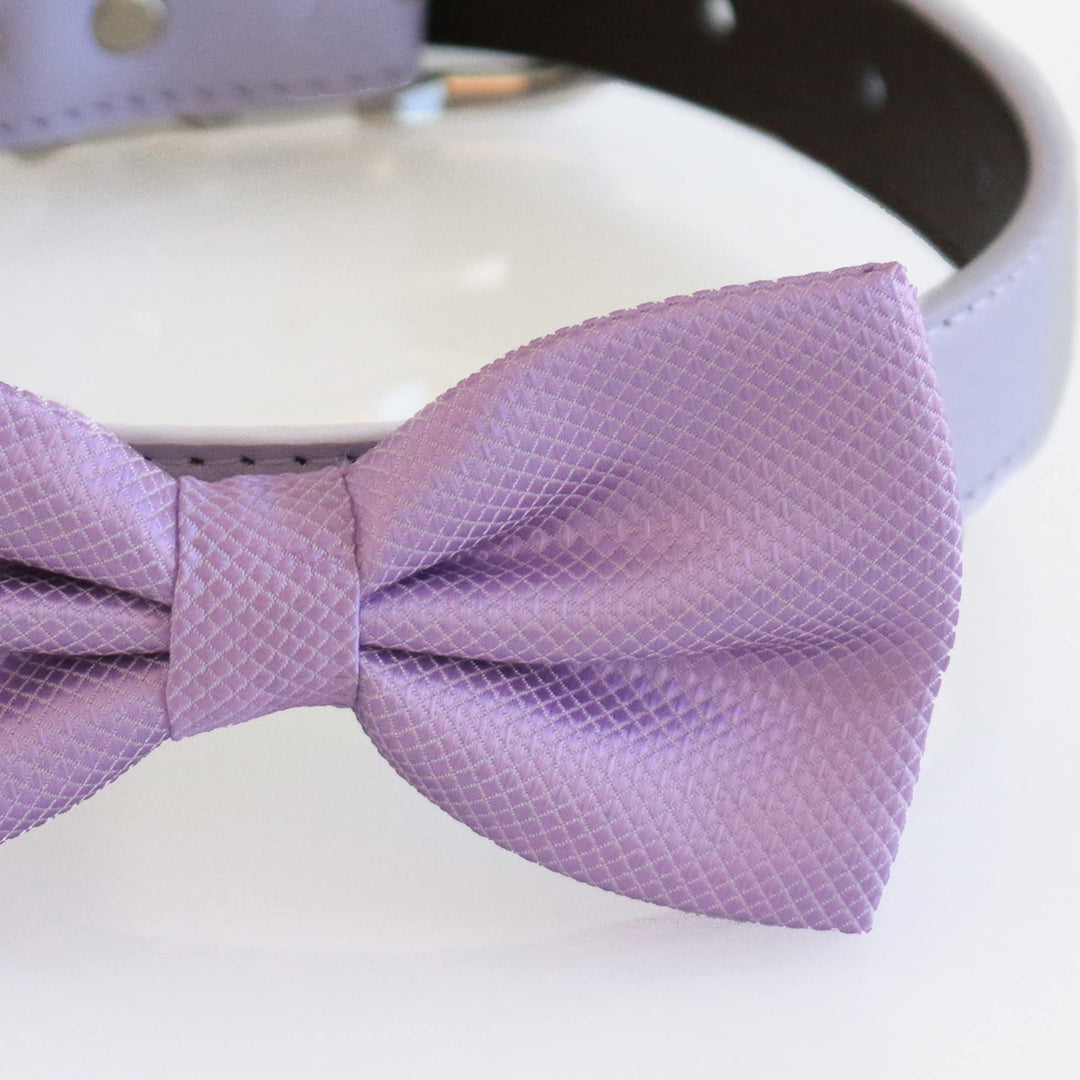 Close-up detail of a lilac satin dog bow tie showing textured woven fabric and center knot
