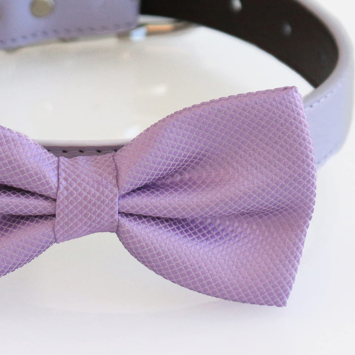 Close-up detail of a lilac satin dog bow tie showing textured woven fabric and center knot