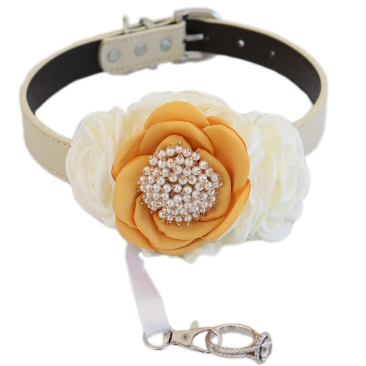 Handmade dog wedding collar featuring a marigold flower centerpiece, ivory side flowers, pearl embellishments, and ring bearer ribbon attachment.