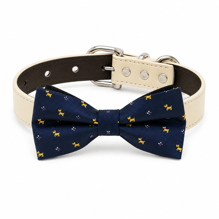 Navy blue dog bow tie collar with playful dog motif pattern, cream vegan leather collar, and silver-tone hardware