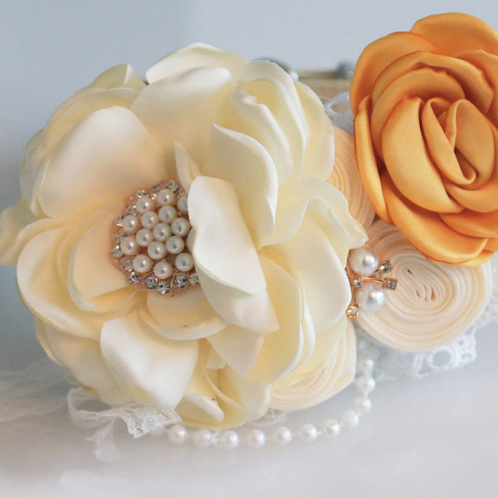 Ivory floral ring bearer dog collar with orange rose accent, pearl centerpiece, lace details, and decorative ribbon attachment.