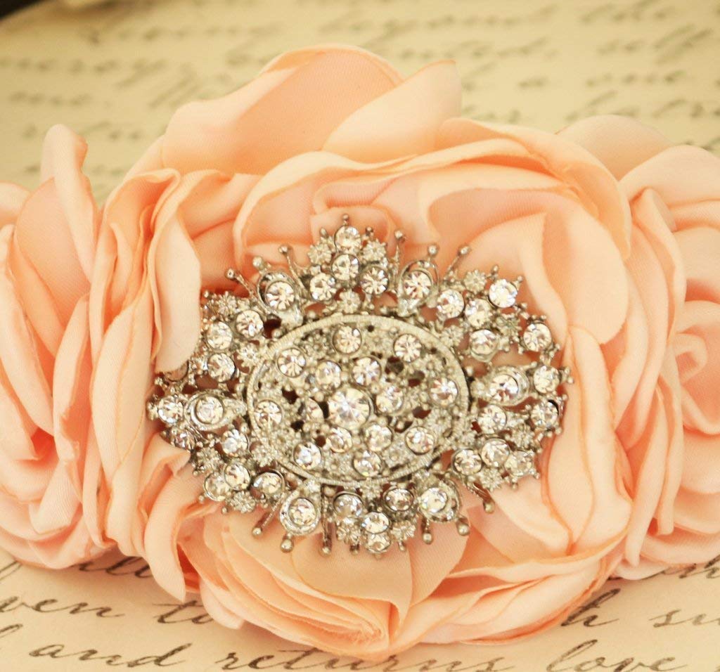 Close-up of peach fabric rose dog collar with ornate rhinestone crystal centerpiece and handmade floral details