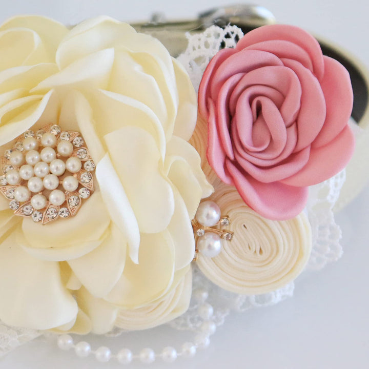 Ivory floral dog collar with soft pink rose accent, pearl brooch centerpiece, lace trim, and decorative pearl details.