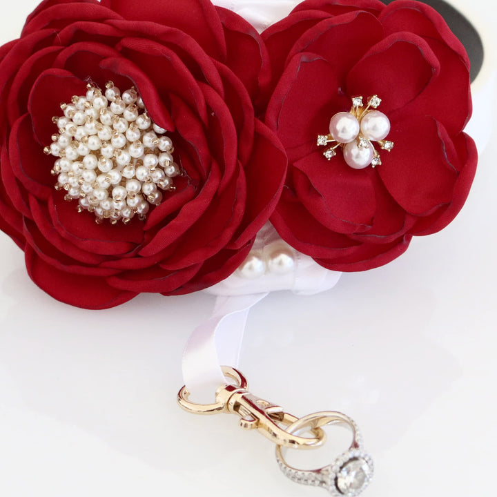 Red floral ring bearer dog collar with pearl embellishments, decorative ribbon, and crystal ring holder clasp