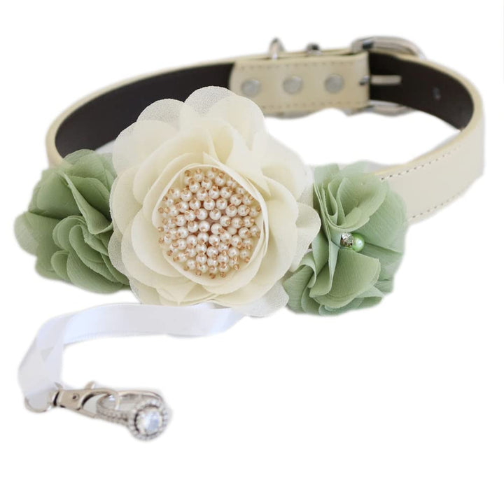 Handmade dog wedding collar featuring an ivory flower centerpiece, sage green floral accents, pearl details, and ring bearer clasp.
