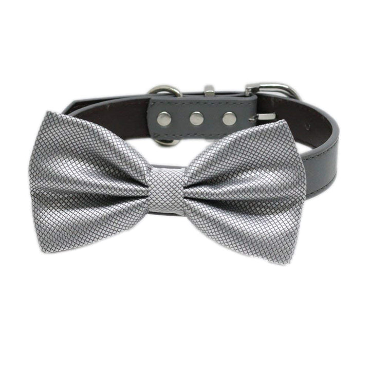 Silver textured satin dog bow tie attached to a black vegan leather dog collar with silver hardware.