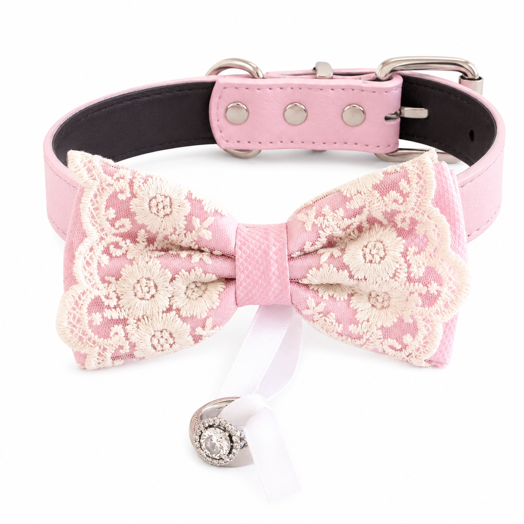 Soft pink lace dog bow tie collar with floral embroidered lace overlay, pink vegan leather collar, adjustable fit, and attached wedding ring holder ribbon