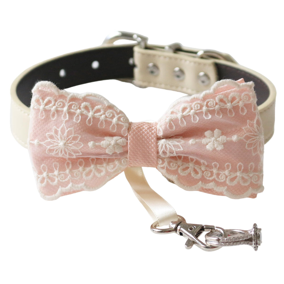 Soft pink ring bearer dog bow tie collar featuring embroidered floral lace detailing, satin center wrap, vegan leather collar, and attached wedding ring holder ribbon for weddings and special occasions