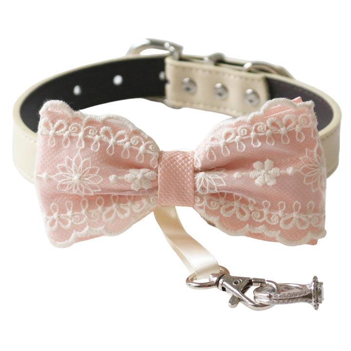 Soft pink ring bearer dog bow tie collar featuring embroidered floral lace detailing, satin center wrap, vegan leather collar, and attached wedding ring holder ribbon for weddings and special occasions