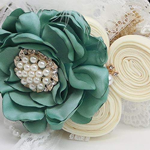Close-up of teal flower ring bearer dog collar with pearl and rhinestone centerpiece, ivory rolled roses, lace accents, and feather detail.