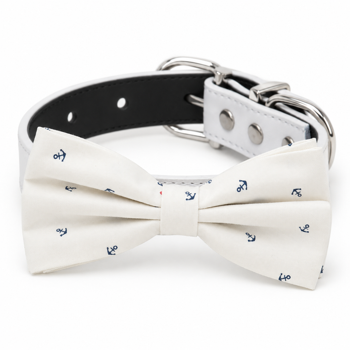 White dog bow tie collar with navy anchor print, white vegan leather collar, and silver-tone hardware