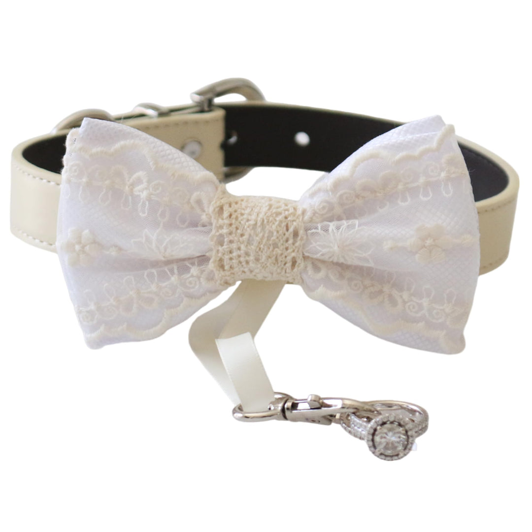 White lace ring bearer dog bow tie collar featuring embroidered lace bow tie, attached wedding ring holder ribbon, decorative wedding ring charm, and adjustable vegan leather collar for weddings and formal events