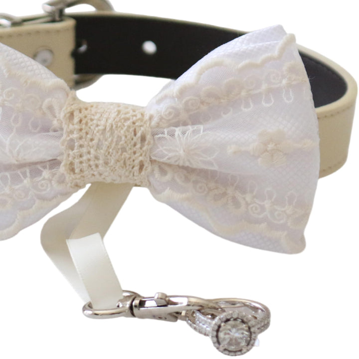 White lace ring bearer dog bow tie collar close-up showing embroidered lace details, attached wedding ring holder ribbon, decorative ring set, and adjustable vegan leather collar