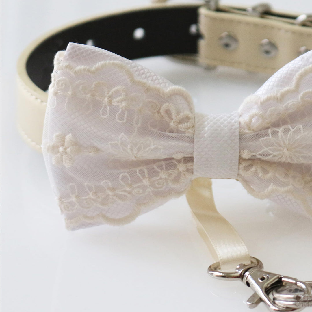 White lace ring bearer dog bow tie collar with embroidered floral lace pattern, white satin center accent, adjustable vegan leather collar, and attached wedding ring holder ribbon