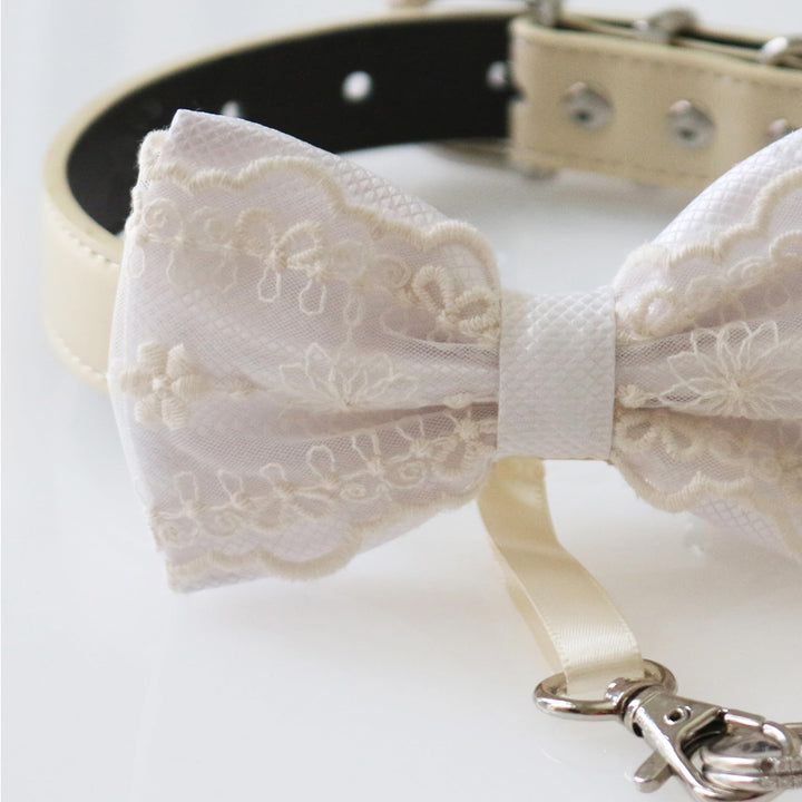 White lace ring bearer dog bow tie collar with embroidered floral lace pattern, white satin center accent, adjustable vegan leather collar, and attached wedding ring holder ribbon