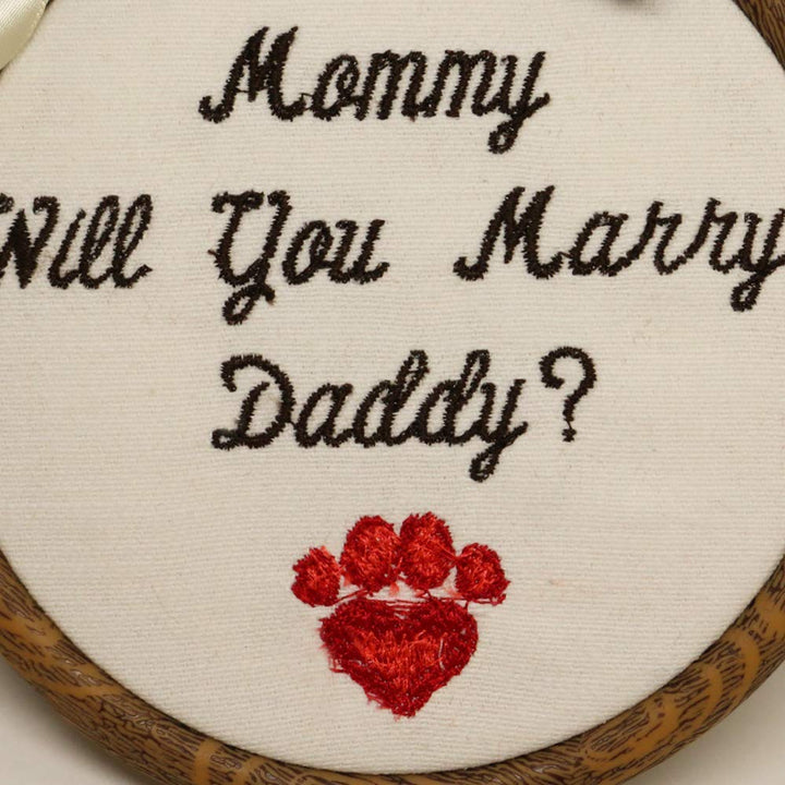 Close-up embroidery detail showing “Mommy Will You Marry Daddy?” message on ring bearer dog proposal sign