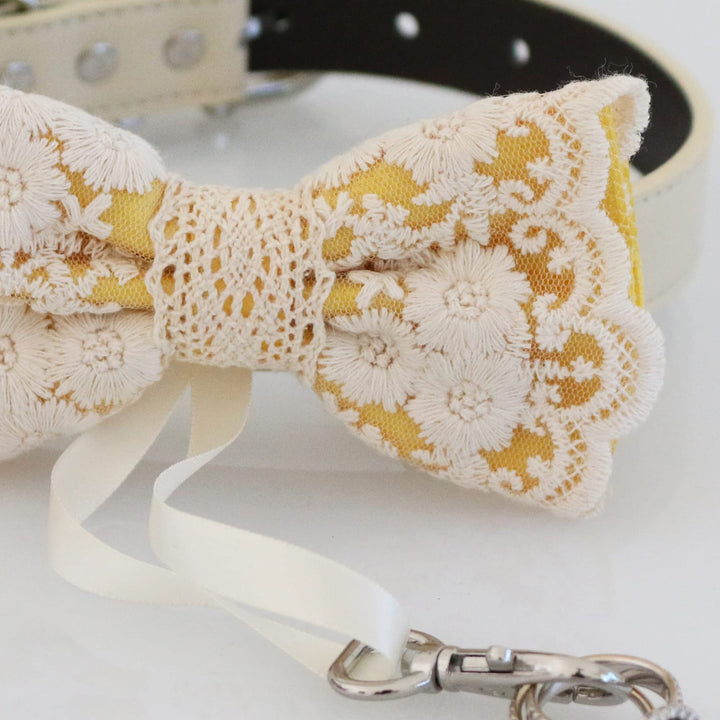Yellow lace ring bearer dog bow tie close-up with embroidered floral lace overlay, crochet center detail, and attached wedding ring holder ribbon