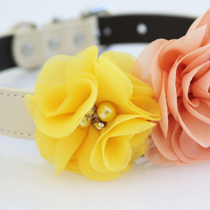 Close-up of handmade yellow and peach fabric flowers with pearl and crystal accents on a floral dog collar