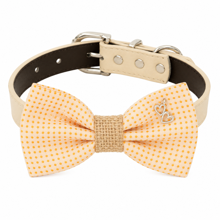 Yellow polka dot dog bow tie collar with heart charm, woven center band, and cream vegan leather collar