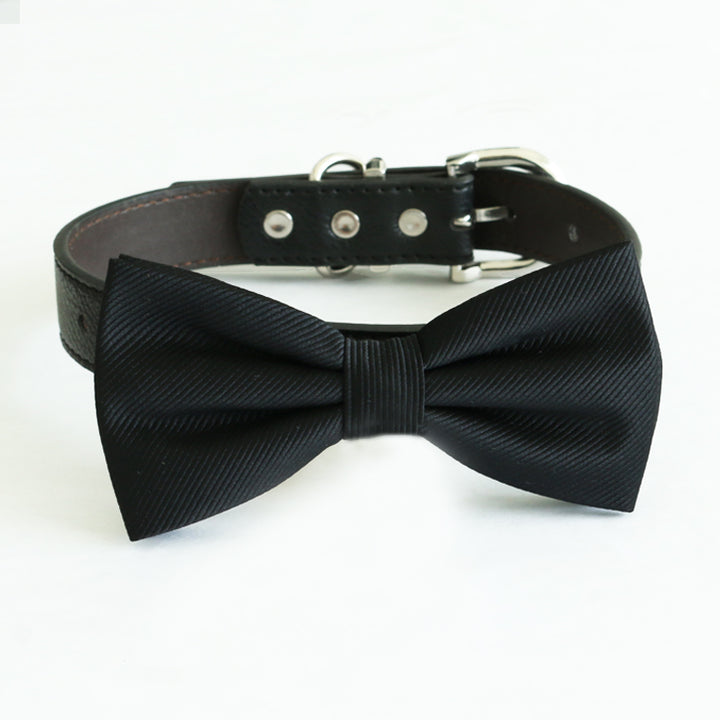 Black satin dog bow tie attached to a black vegan leather collar with silver-tone hardware