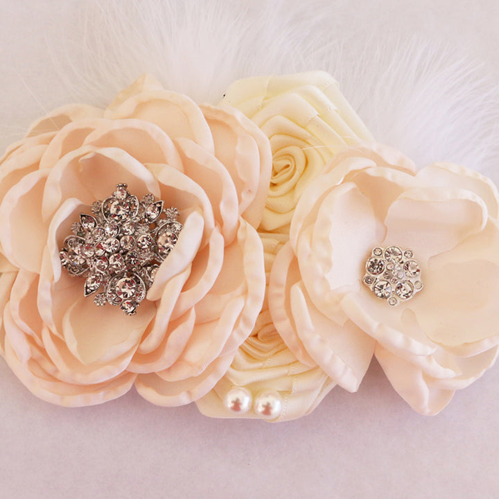 Blush ivory floral wedding dog collar with rhinestone flower centers, handcrafted fabric flowers, feather accents, and elegant bridal styling.
