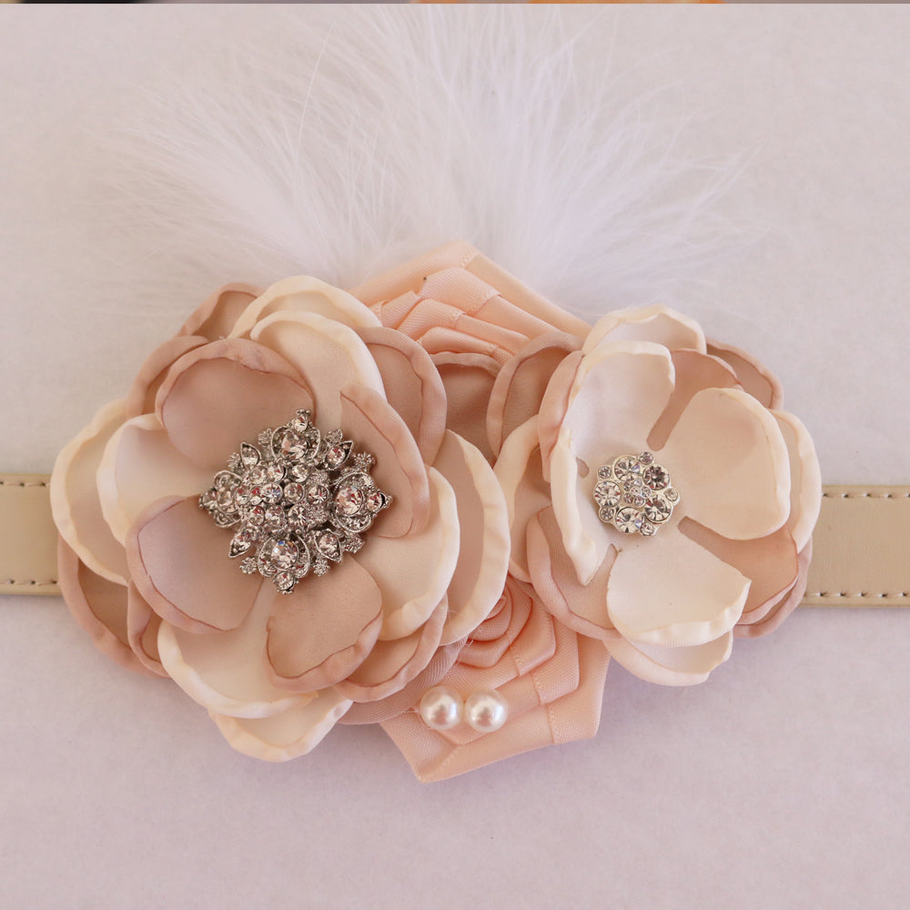 Wedding dog collar featuring blush champagne flowers, crystal embellishments, pearl details, and decorative feather accent.
