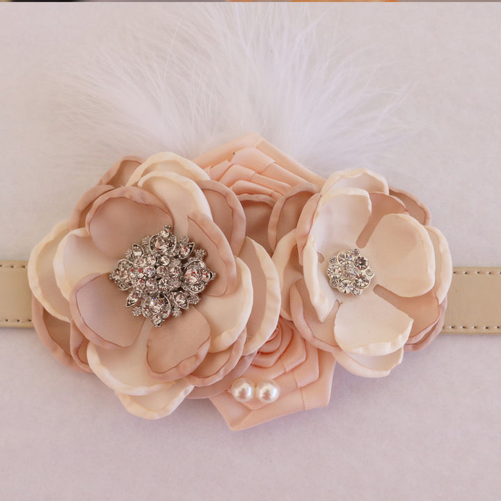 Wedding dog collar featuring blush champagne flowers, crystal embellishments, pearl details, and decorative feather accent.