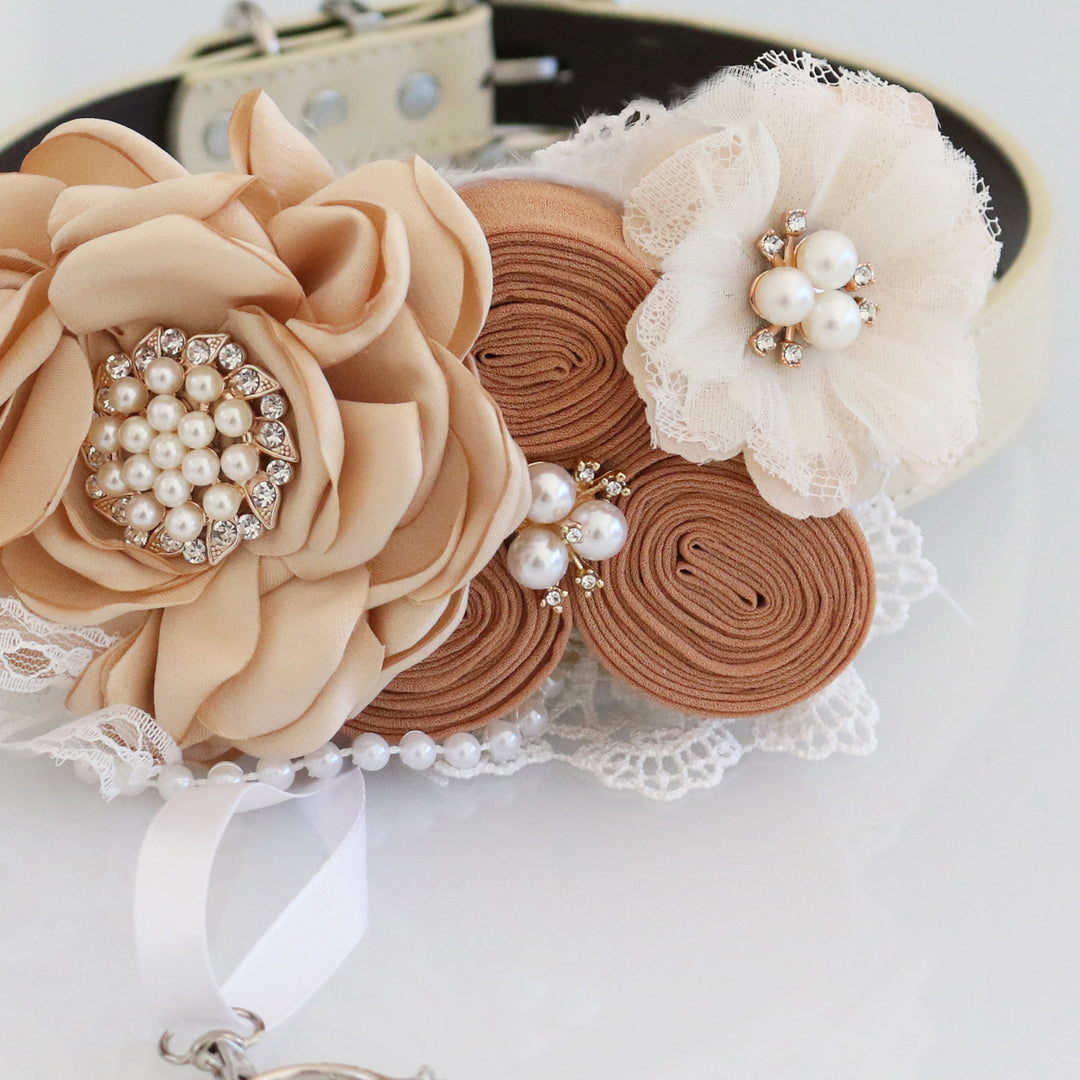 Close-up of champagne floral ring bearer dog collar with pearl centerpiece, handmade rosette flowers, lace accents, and wedding ring holder ribbon.