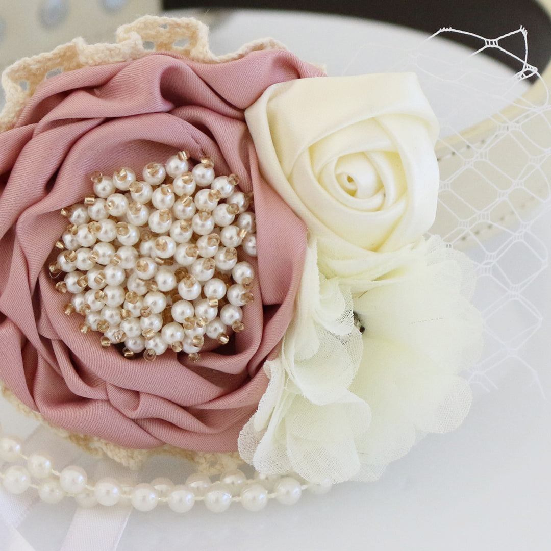 Close-up of dusty rose floral dog collar with pearl center flower, ivory rose accent, lace details, and pearl garland.
