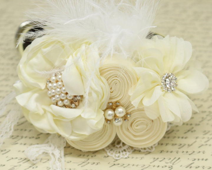 Ivory floral dog wedding collar with feather accents, pearl flower centerpiece, lace details, and decorative rosette flowers.